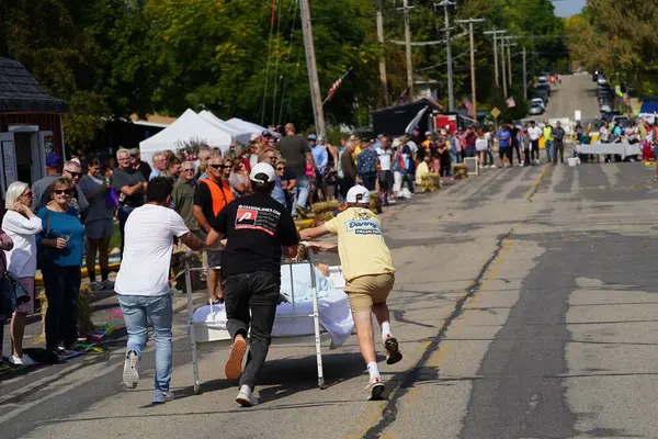 stock image Green Lake, Wisconsin USA - September 23rd, 2023: Community members enjoyed a family event of bed racing on the streets of Green Lake.