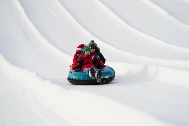 Kewaskum, Wisconsin / ABD - 24 Aralık 2019: Birçok aile ferdi Noel 'den bir gün önce Noel Slalom etkinliği için Sunburst Kış Spor Parkı' na kar borusu dökerek eğlenmeye geldi..  