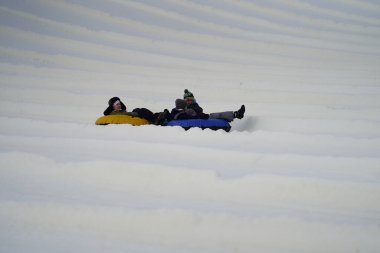 Kewaskum, Wisconsin / ABD - 24 Aralık 2019: Birçok aile ferdi Noel 'den bir gün önce Noel Slalom etkinliği için Sunburst Kış Spor Parkı' na kar borusu dökerek eğlenmeye geldi..  