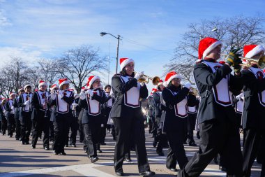 Green Bay, Wisconsin / USA - November 23rd, 2019: Green Bay East High School Red Devils musical marching band marched in 36th Annual Prevea Green Bay Holiday Parade hosted by Downtown Green Bay. clipart