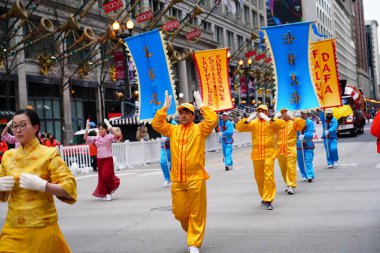 Chicago, Illinois USA - November 23rd, 2023: Members of Falun Dafa Chicago, Falun Gong Chicago a Chinese religion practice participate in 2023 Chicago Thanksgiving Day Parade. clipart