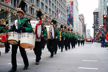 Chicago, Illinois USA - November 23rd, 2023: Kelly High School Trojans Musical Marching Band of Chicago marched in 2023 Chicago Thanksgiving Parade clipart