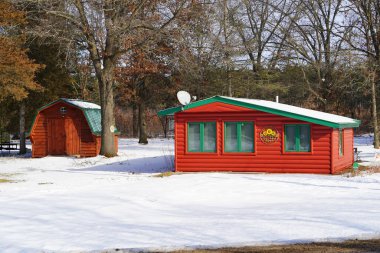 Yeni Lizbon, Wisconsin ABD - 24 Ocak 2023: Küçük kırmızı kulübe, kış karının içinde duruyor.