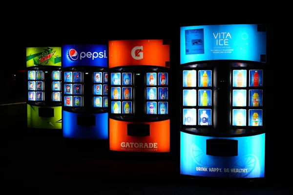 Stock image New Lisbon, Wisconsin USA - November 17th, 2023: Soda and drink dispenser machines sit at the roadside glowing during the night.