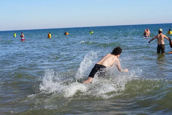 stock image Milwaukee, Wisconsin / USA - January 1st, 2020: Many community members participated in Polar Bear Plunge into the freezing waters of Lake Michigan during the cold winter season.