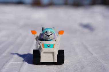 New Lisbon, Wisconsin USA - March 14th, 2023: Spin Master Paw Patrol Everest and Chase kids toys placed outside in the cold winter. clipart