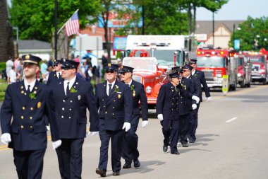 Wisconsin Dells, Wisconsin USA - May 31, 2021: Kilbourn Volunteer Fire Department rescue men walked and marched in the memorial day parade. clipart