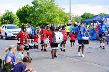 Milwaukee, Wisconsin USA - June 19th, 2021: African American drummer band participating and marching in Juneteenth celebration parade. clipart