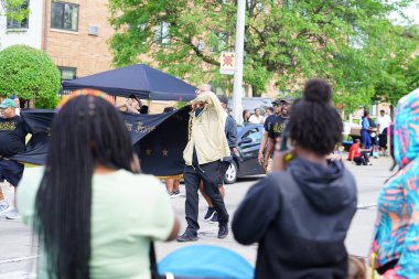 Milwaukee, Wisconsin USA - June 19th, 2021: Black African-American fraternities participated and walked in Juneteenth celebration parade. clipart