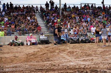 Pickett, Wisconsin / USA - September 18th, 2020: Power wheels with kids driven in hollywood motorsports entertainment annual paws for the cause demolition derb clipart