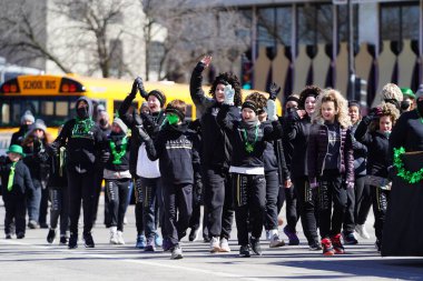 Milwaukee, Wisconsin USA - March 12th, 2022: Members McNamara McCarthy School of Irish Dance danced in St. Patrick's Day parade. clipart