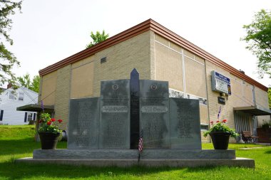 Wisconsin Dells, Wisconsin USA - May 31, 2021: Veteran memorial site and memorial statues standing in front of American Legion Post 187. clipart