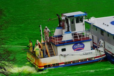 Chicago, Illinois ABD - 16 Mart 2024: St. Patrick Günü 'nde Chicago Nehri' ni boyamak için yeşil boya kullanan tekne mürettebatı.
