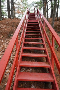 A path of Red stairs lead up a rocky hillside at Rockbridge, Wisconsin clipart