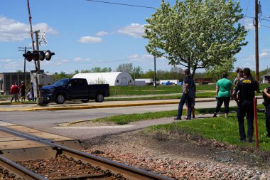 Tomah, Wisconsin USA - May 5th, 2024: People waited at an Amtrak train depot to take their ride. clipart