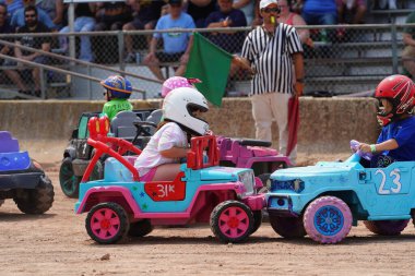 Fond du Lac, Wisconsin USA - July 21st, 2024: Power wheels with kids driven in Hollywood Motorsports Entertainment annual paws for the cause at Fond du Lac county fair. clipart