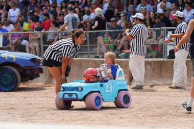 Fond du Lac, Wisconsin USA - July 21st, 2024: Power wheels with kids driven in Hollywood Motorsports Entertainment annual paws for the cause at Fond du Lac county fair. clipart