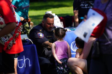 Fond du Lac, Wisconsin USA - 6 Ağustos 2024: Yerel Polis, Şerif ve İtfaiye Memurları, Ulusal Gece Yarısı Aile Eğlencesi etkinliği için topluluk aileleriyle bir araya geldi.