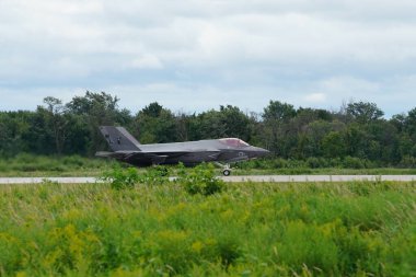 Camp Douglas, Wisconsin USA - August 9th, 2024: United States Air Force fighter jets F-35 and F-16 took off and landed at Volk Air Field during the Northern Lighting Combat training exercise. clipart