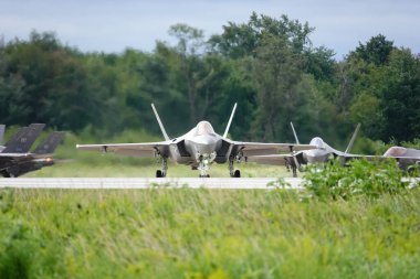 Camp Douglas, Wisconsin USA - August 9th, 2024: United States Air Force fighter jets F-35 and F-16 took off and landed at Volk Air Field during the Northern Lighting Combat training exercise. clipart