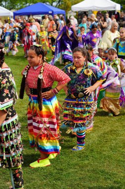 Neenah, Wisconsin USA - September 14th, 2024: Native American men, women and children danced together at an annual Powwow event. clipart