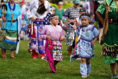 Neenah, Wisconsin USA - September 14th, 2024: Native American men, women and children danced together at an annual Powwow event. clipart