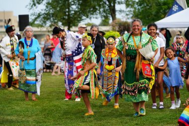 Neenah, Wisconsin USA - September 14th, 2024: Native American men, women and children danced together at an annual Powwow event. clipart