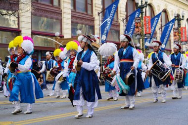 Chicago, Illinois USA - November 23rd, 2023: Members of Korean Performing arts institute of Chicago marching band marched through State Street during Thanksgiving Day Parade. clipart