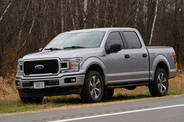 New Lisbon, Wisconsin USA - December 2nd, 2024: Light Grey 2020 Ford F-150 truck sits on the side of the road out in the countryside.