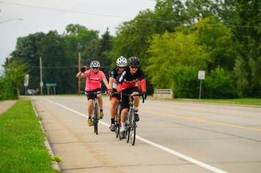 Fond du Lac, Wisconsin USA - 18 Ağustos 2024: Erkek bisikletçiler sabahın erken saatlerinde bisiklet sürüyorlar