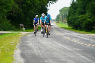 Fond du Lac, Wisconsin USA - 18 Ağustos 2024: Erkek bisikletçiler sabahın erken saatlerinde bisiklet sürüyorlar