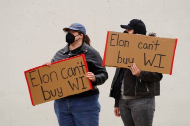 Madison, Wisconsin ABD - 29 Mart 2025: Liberal Demokratlar, Tesla Takedown ulusal etkinliği sırasında Tesla bayilik galerisi önündeki büyük bir gruptaki pankartlarla protesto ettiler.