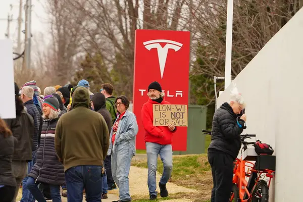Madison, Wisconsin ABD - 29 Mart 2025: Liberal Demokratlar, Tesla Takedown ulusal etkinliği sırasında Tesla bayilik galerisi önündeki büyük bir gruptaki pankartlarla protesto ettiler.