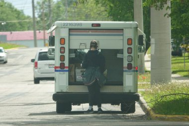 Fond du Lac, Wisconsin USA - 12 Mayıs 2025: USPS Posta Teslimatı. Teslimat kamyonundaki postacı.