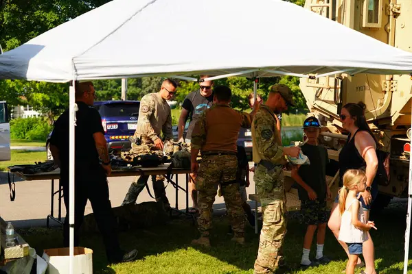 Tomah, Wisconsin ABD - 5 Ağustos 2025: Yerel Polis, Şerif ve İtfaiyeci memurlar, Ulusal Gece Gezisi Aile Eğlencesi etkinliği için cemaat aileleriyle bir araya geldi.