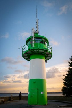 the green-white lighthouse in the harbor of Luebeck Travemuende