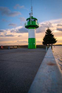 the green-white lighthouse in the harbor of Luebeck Travemuende