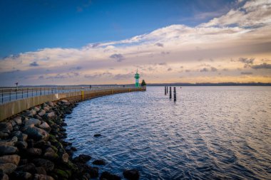 the green-white lighthouse in the harbor of Luebeck Travemuende