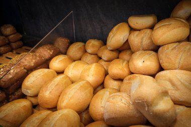 Fırının vitrininde yeni pişmiş ekmek ruloları var.