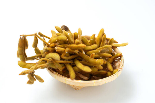Raw edamame soya beans with salt and sauce on light gray background. Top view, copy space. Fresh steamed edamame sprinkled with sea salt. Asian snack food in bowl