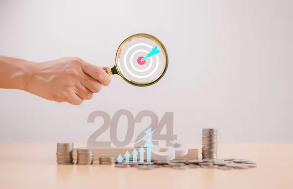 Target Goal challenge concept. Start calendar 2024 plan . Businessman use magnifying glass search for seo marketing action, business survival trend 2024 strategy. Person planning growth New year