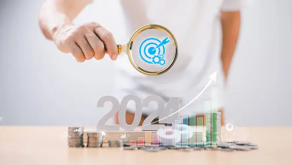 Target Goal challenge concept. Start calendar 2024 plan . Businessman use magnifying glass search for seo marketing action, business survival trend 2024 strategy. Person planning growth New year