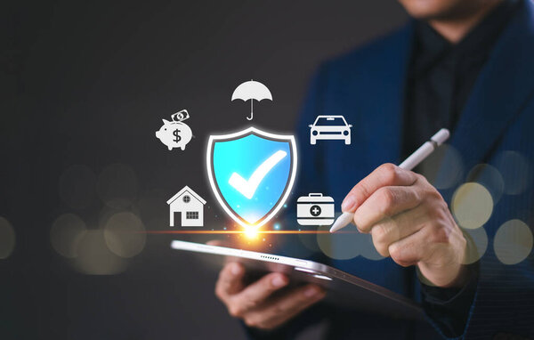 Insurance online agent solution concept, life, family, health, and financial technology. Businessman use tablet giving insurance and assurance icon, real estate, car and finance for risk management.