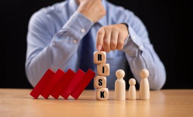 Risk değerlendirme krizi konsepti. Finansal analiz çözümü, kredi işi yönetimi. Sigorta teknolojisi ev kredisini korur. Ev güvenliği aile hayatı. İşadamı. Kırmızı tahta domino bloğu.
