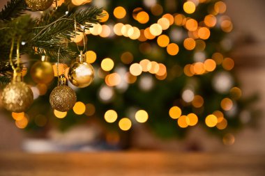 Close up view of beautiful fir branches with shiny decorations, baubles, xmas ornaments and lights, christmas holidays background.