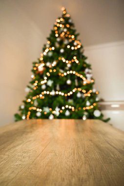 Güzel dekore edilmiş bir ağacı, şenlikli çelenkleri, yanıp sönen ışıkları, ağacın altındaki hediyeleri ve şöminenin yanındaki aile sıcaklığını olan rahat bir Noel atmosferi..