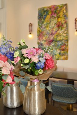 Bitmiş çiçek buketleri atölye sırasında bir vazoda sergilenir.