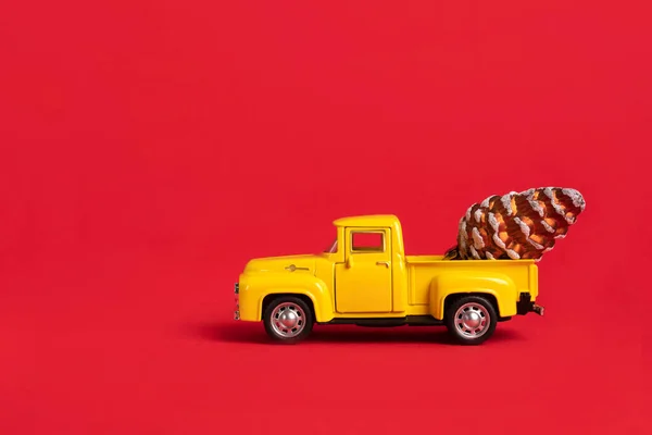 Yellow Retro Toy Pickup Carrying Tree Cones Red Background Christmas — Stock Photo, Image