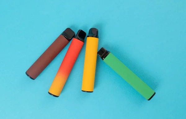 Set Colorful Disposable Electronic Cigarettes Blue Background Concept Modern Smoking — Fotografia de Stock