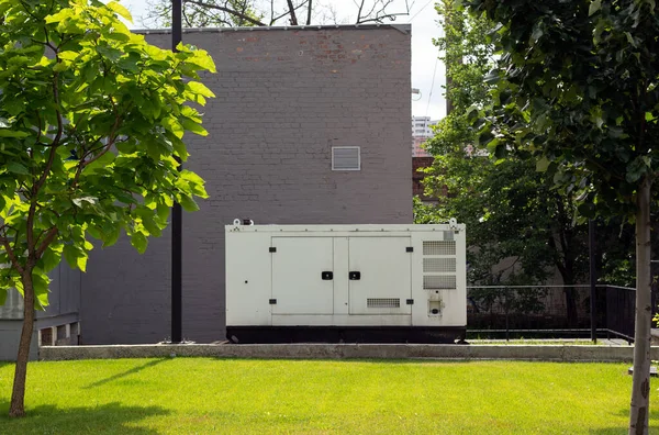 stock image auxiliary diesel generator for emergency power supply. Industrial generator connected to the control panel by a cable wire. Backup power supply of the generator